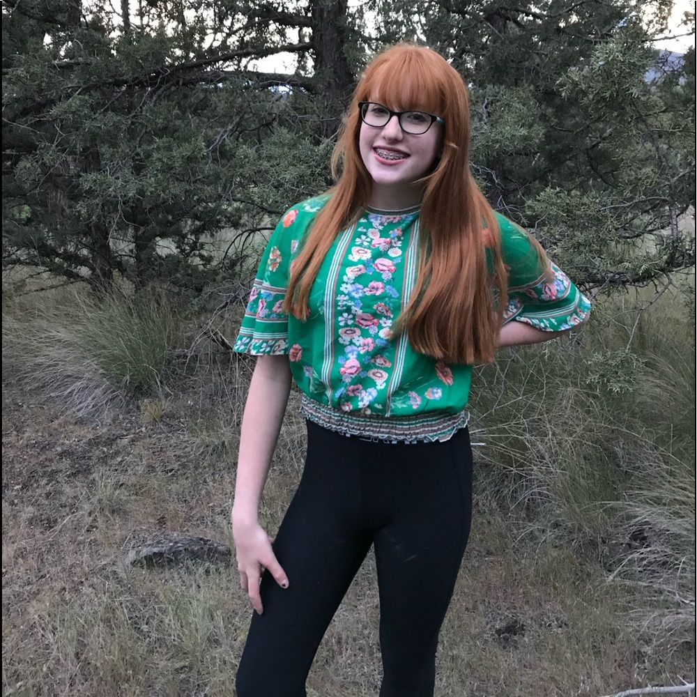 A green flowered paired with  under armor pants